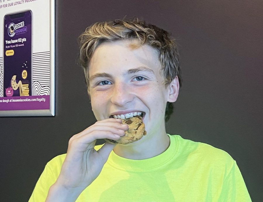  Junior Braden Dennis delightfully eats his chocolate chip deluxe cookie from Insomnia’s cookies. “The rich flavor of the chocolate chip really made the cookie amazing,” Dennis said. 
