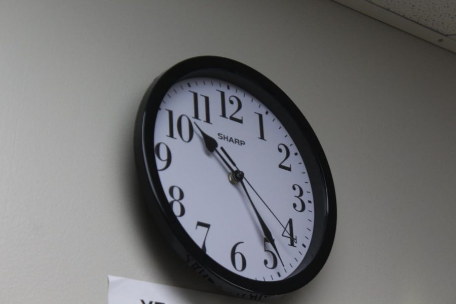 A clock in the journalism room. An Instrument used to tell time.