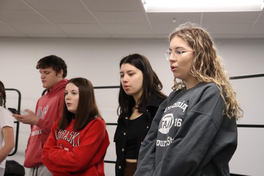 Charles Speake (11, left), Abigail Conrad (11), Madison McGinnis (11) and Molly Rees (9) sing with the a cappella group during a rehearsal.