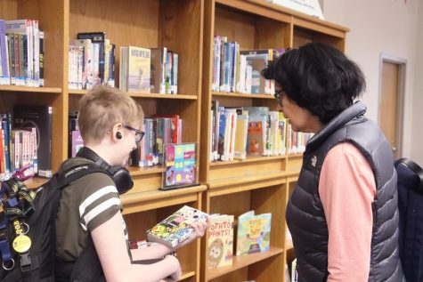 Elly Stopczynski, senior, talks to reporter Sue Halpern about one of the graphic novels in the library.