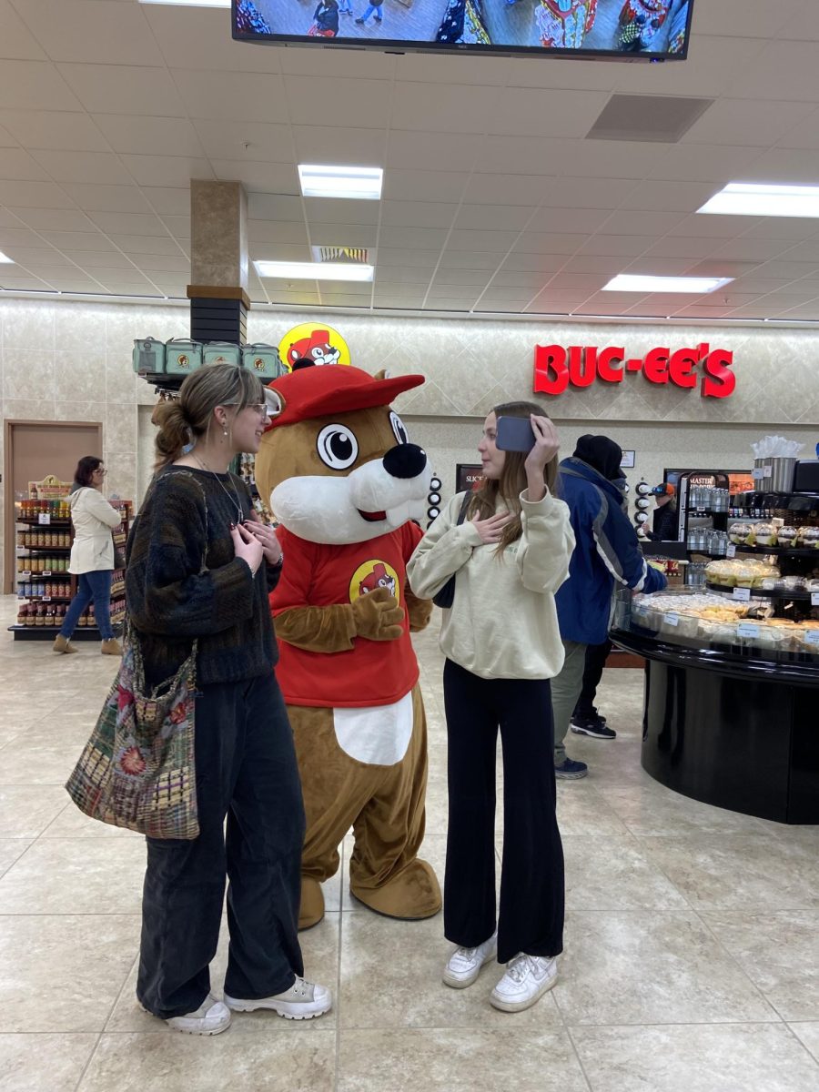 Wingspan staff members Laurel Latimer and Chloe Fischer film themselves with Buc-ee the Beaver for an EagleAir vlog and news story.