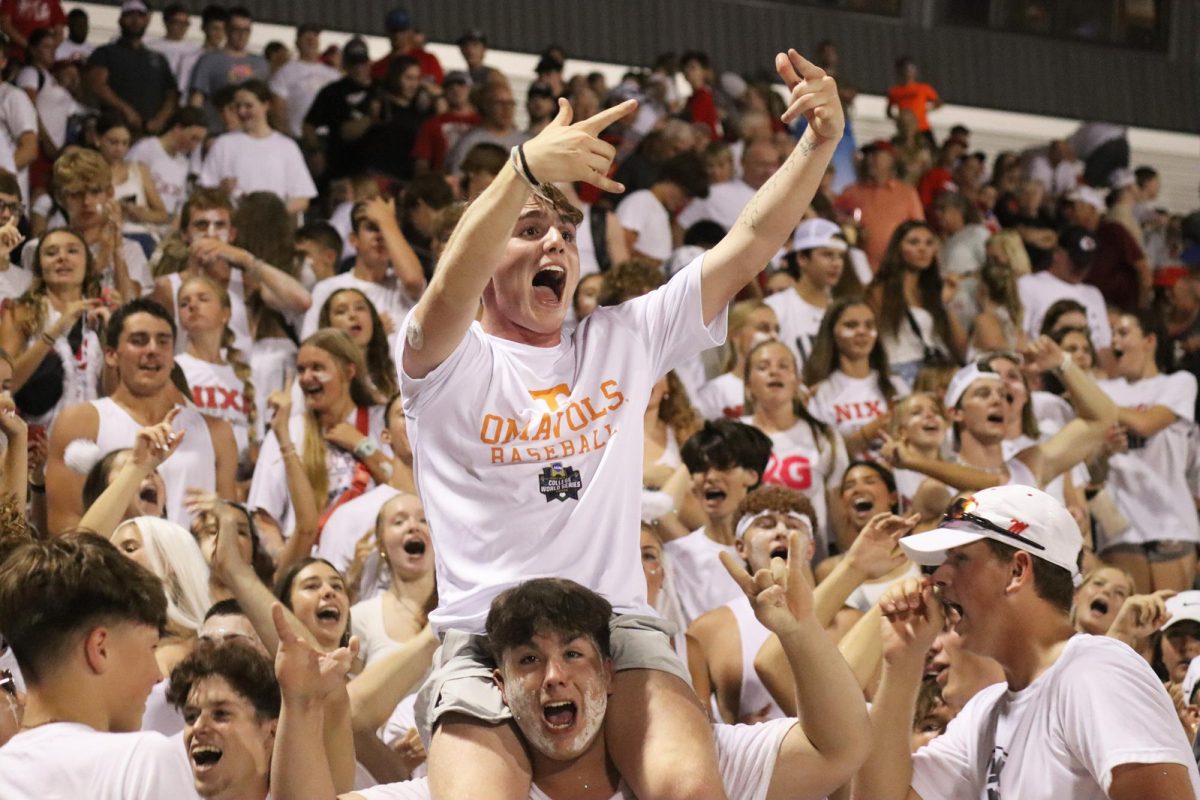 During+the+hottest+Nixa+football+game+of+the+season+that+took+place+on+Aug.+25%2C+2023+against+Webb+City+a+sea+of+students+erupts+in+cheers.+With+sweat+dripping+down+their+faces%2C+Payton+Link+%2812%29+supported+by+classmate+Andrew+Banks+%2812%29+show+their+support+for+the+Nixa+football+team+after+their+first+win+of+the+2023-2024+season.+%E2%80%9C%5BThat+game%5D+was+really+cool%2C+it+kind+of+set+the+tone+for+the+season+after+beating+the+Webb+City%2C%E2%80%9D+Link+said.+%E2%80%9CIt+got+me+really+excited+for+the+remainder+of+the+season.%E2%80%9D%0AThis+photo+won+Best+of+Show+at+the+2024+J-Day+celebration.