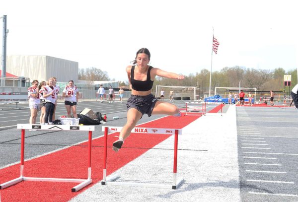 Senior Camila Figueroa successfully crosses a hurdle. Hurdles are one of the many different events preformed during a meet. “I like the competition,” freshman Jonah Fields said. “I like the heat of the moment and being my best.” 
