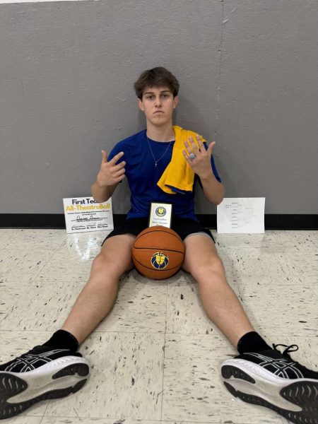 Deacon Brown (11) shows off all of the awards he earned from leading his team, The Mailmen, to the championship and from earning most valuable player in the tournament. 