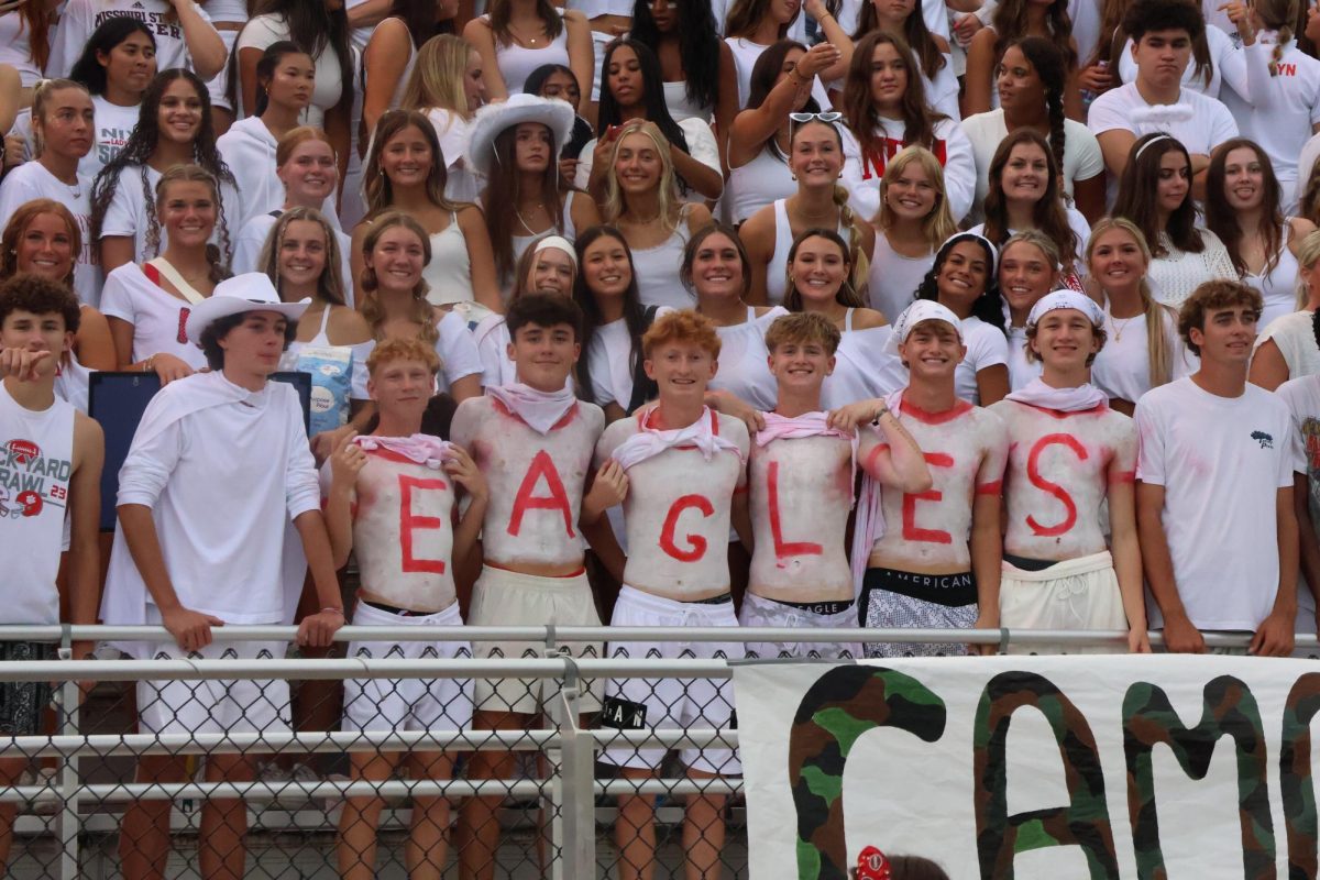 From Left spelling out the word “EAGLES”- Seniors Troy Huff (E), Bryce Peebles (A), Mason Duncan (G), Peyton Harris (L), Noah Schiman (E), and Kyle Griffin (S) show their team spirit by painting their chests with each letter of the word “EAGLES” during Nixa’s week one matchup against Republic
