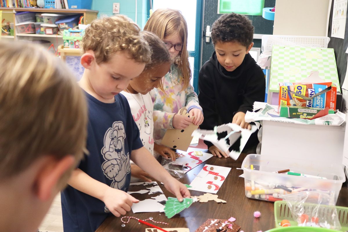 Kindergarten students Asher Willis, Camila Bracken-Yanders, Adeline James and Cyrus Gideon work on a Santa-themed art project in Rebecca Edward's classroom. 