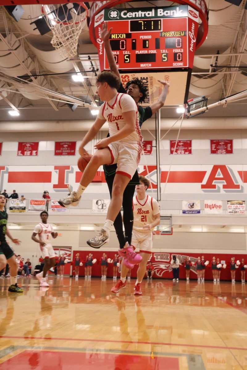 Senior Bryce Foster makes a flashy pass to sophomore Adam McKnight in their varsity game against Parkview’s boys’ basketball team.