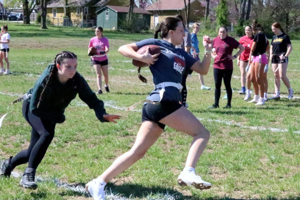 Freshman Natalie Blevins takes a flag from junior Esther Dancey during flag football practice at the Early Learning Center in Nixa.
