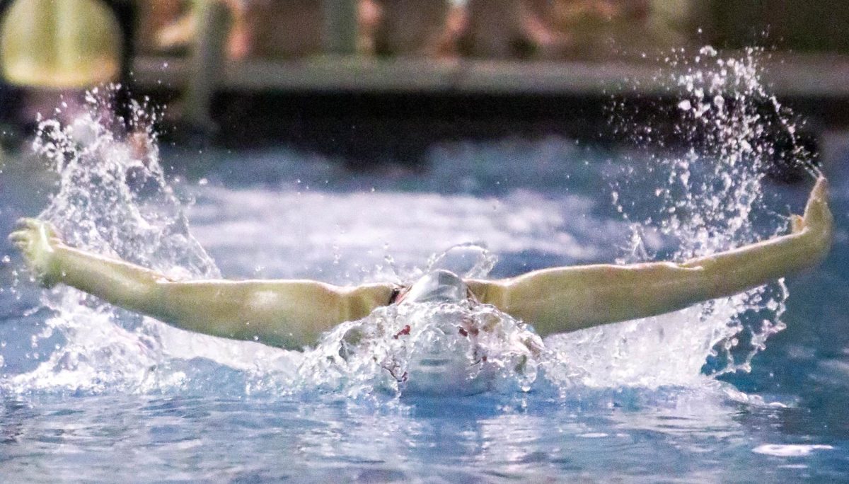 Senior Alivia Giddens warming up for the competition through the waters of the Ozarks Invite.
