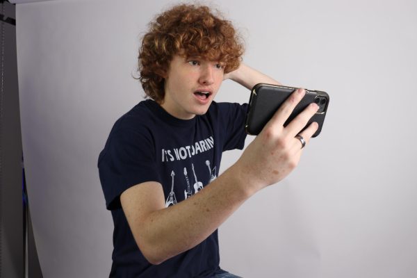Sophomore John Knoop reacts to a request for age verification on YouTube.  According to Globalmediainsight.com, 87 percent of social media users are 18 or older, and roughly 90 percent of teens use YouTube.
