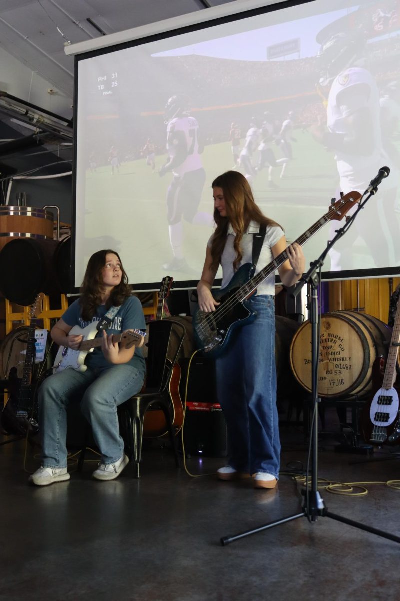 Willa Roper and Riley Willaby, sophomores at Strafford High School, play La Paura Del Buio by Måneskin at a showcase for people who take lessons at Guitar Center in Springfield. 
