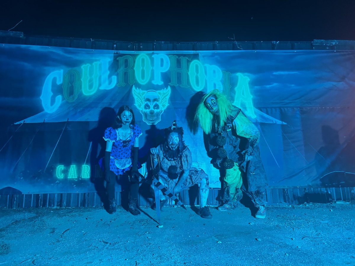 Scare actors pose outside of Field of Screams new clown attraction, Coulrophobia.