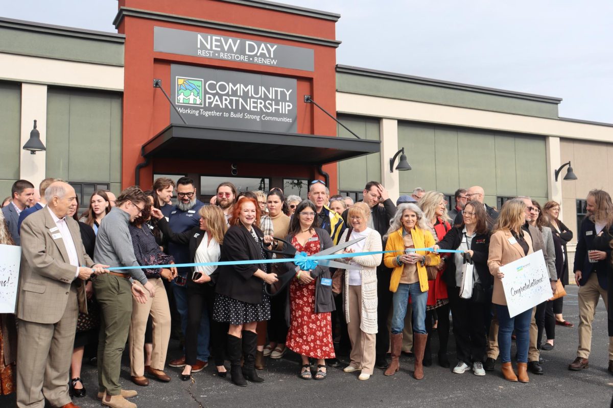 Janet Dankert the President of Community Partnership of the Ozarks cuts the ribbon of New Day for opening. 
