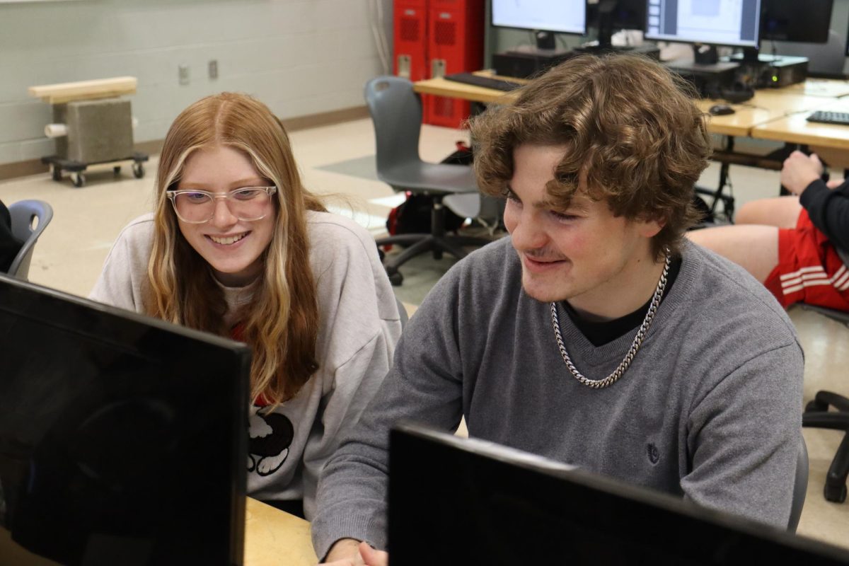 Kaydn Garland and Ryan Davis laugh to each other as they work on their engineering assignment.