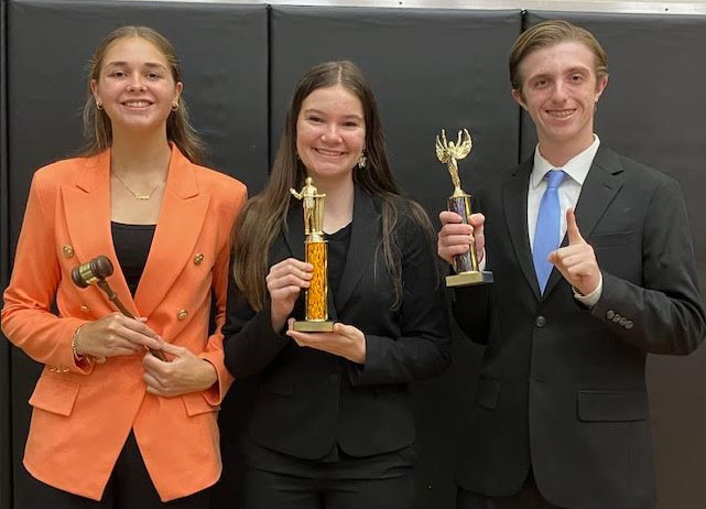 Sophomore Reese Morris, left, freshman Ava Harvey and freshman Broghan Dee celebrate achievements in speech and debate.