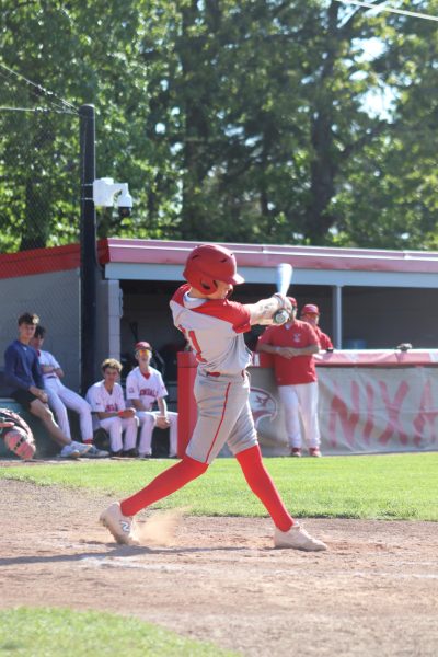 Freshman Jett Kellis is up to bat, hitting the ball making the score 10-0.
