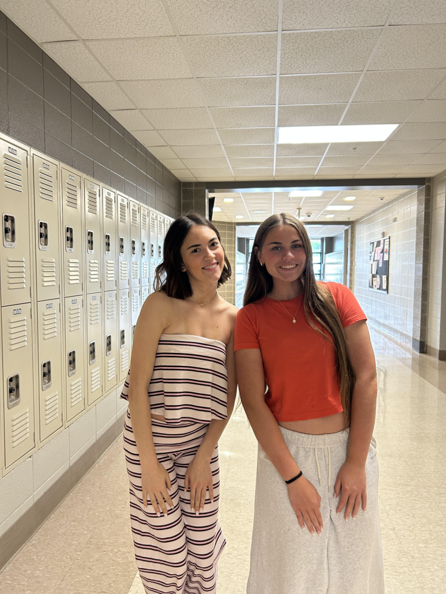 Senior Kathleen Voges and freshman Lucy Holgate pose for the picture in the journalism hallway May 6. Voges has been at the high school for 4 years and signs out with a bang, “Leaving high school is so bittersweet, but I am thrilled to start on my career path” Voges said.
